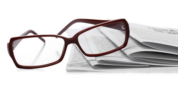 Glasses and newspapers, close-up - Фото, изображение