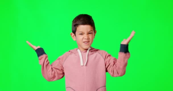 Green screen, confused and annoyed child shrugging shoulders feeling angry isolated in a studio background. Frustration, unsure and portrait of clueless boy kid doing doubt hand gesture or reaction. - 映像、動画