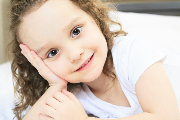 A portrait of a little girl on bed - Zdjęcie, obraz