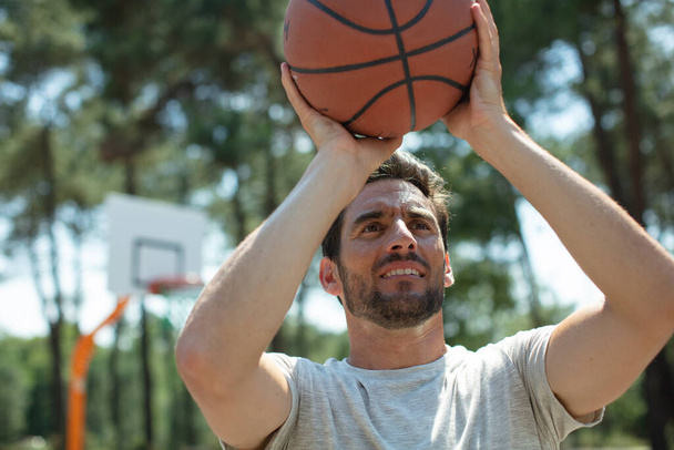a male playing basketball outdoor - Фото, зображення
