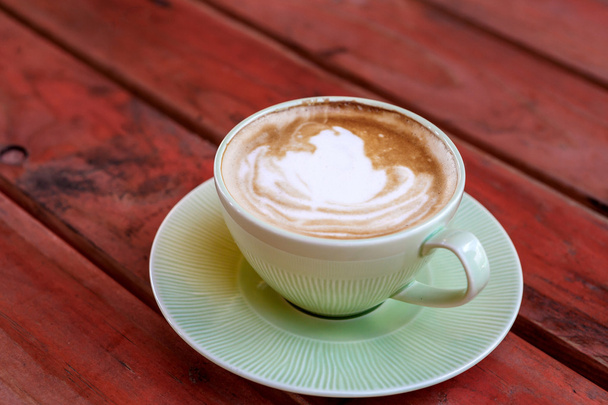 Coffee cup on red table - Фото, зображення