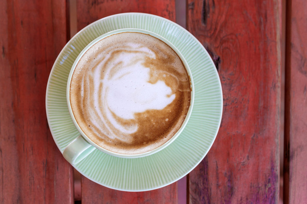 Coffee cup on red table - Фото, зображення