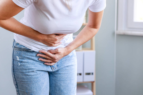Young woman having painful stomach ache. Chronic gastritis. Stomach or menstrual cramps. Abdomen bloating concept. - Φωτογραφία, εικόνα