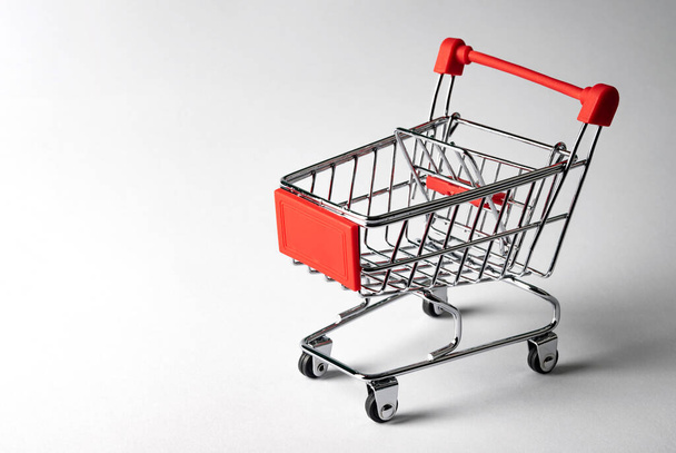 Empty shopping trolley on white background - Foto, afbeelding