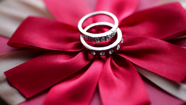 Wedding rings on a red bow - Footage, Video
