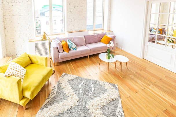 Scandinavian style apartment interior. bright yellow warm colors. wooden flooring. sunlight in large windows. - Φωτογραφία, εικόνα