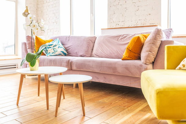Scandinavian style apartment interior. bright yellow warm colors. wooden flooring. sunlight in large windows. - Фото, зображення