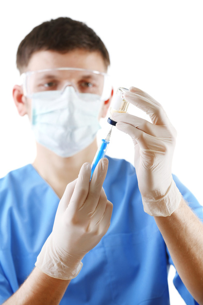 Doctor dialing medicine into syringe from glass bottle isolated on white background - Photo, image