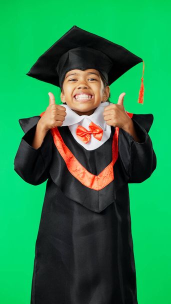 Graduation, happy and face of a child with a thumbs up on a green screen isolated on a studio background. Success, achievement and portrait of an excited girl with an emoji sign for education. - Photo, Image