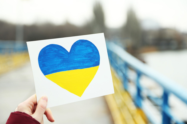 Heart with painted Ukraine flag - Foto, Imagen