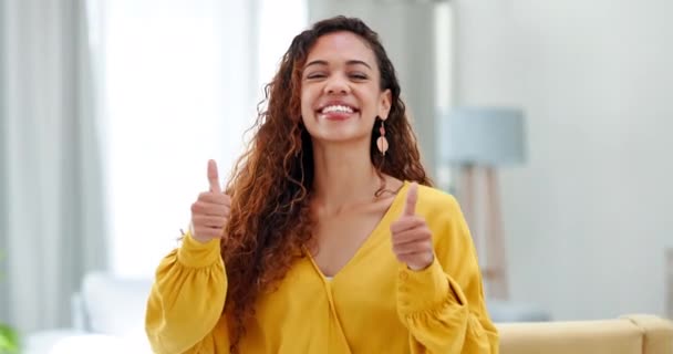 Happy woman, face and thumbs up with smile for winning, good job or success in living room at home. Portrait of excited female smiling and showing hands or thumb emoji, yes sign or like for agreement. - Footage, Video