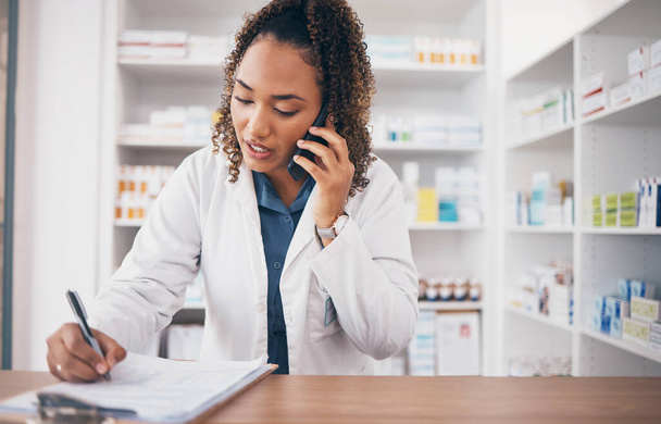 Phone call, pharmacist woman and writing on medicine checklist, customer service or virtual pharmacy support. Serious doctor with medical notes, health insurance documents and talking at help desk. - Fotoğraf, Görsel