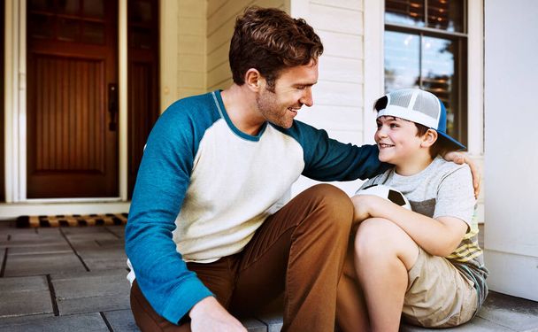 Dad is always there to support and encourage. a father and his son bonding on their porch at home - Foto, imagen