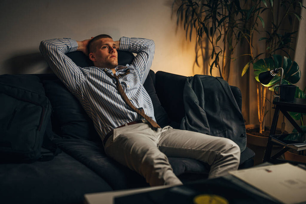 A businessman enjoys listening to records at home after a hard day at work - Foto, Imagen