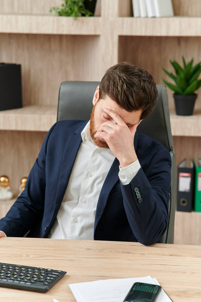 an executive or an office worker closing his eyes from the tiredness, and headache and migraine - Foto, Imagem