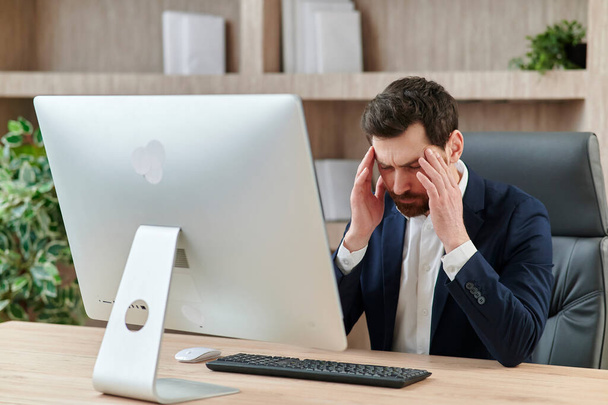 an executive or an office worker closing his eyes from the tiredness, and headache and migraine - Foto, Imagem