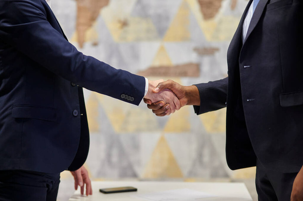 Positive closure of the business meeting. Interracial handshake - Foto, Imagen