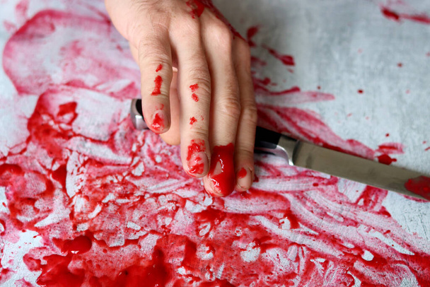 Hand Knife on bloody messy background with copy space. Suicide Homicide Abuse Domestic killing concept. Bloody hand holding a knife with blood.  - Φωτογραφία, εικόνα