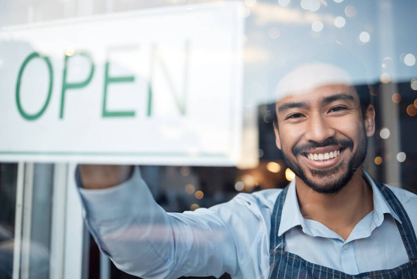 Asian man, small business and portrait smile with open sign on window for service in coffee shop or restaurant. Male entrepreneur or manager with billboard or poster for opening retail store or cafe. - Photo, image