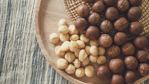 Organic Macadamia nut. macadamia nuts are cracked and baked to taste extremely delicious superfood fresh natural shelled macadamia and healthy food concept - Fotografie, Obrázek