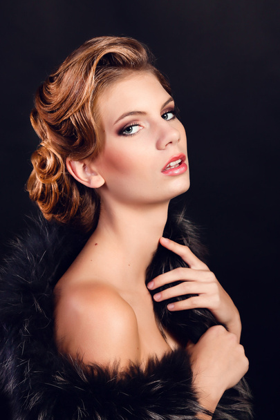 Elegant young woman in black lingerie posing at studio. - Foto, imagen