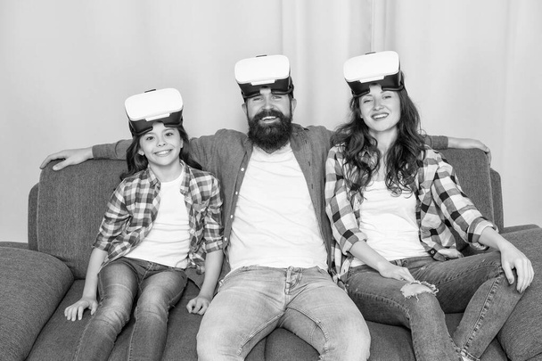 father mother and child wireless VR glasses. virtual reality family. happy parents with kid girl use modern technology. mom dad and daughter. digital future and innovation. modern life. - Фото, зображення