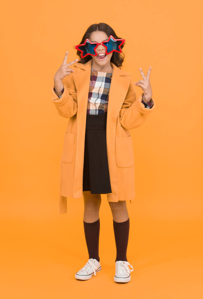 Party girl. Happy child make victory hand gestures. Little kid celebrate victory yellow background. Cute small winner enjoy victory party. School competition. Victory and triumph. - 写真・画像