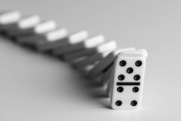 simple classic white domino tiles on a light background , black and white photo - Photo, Image