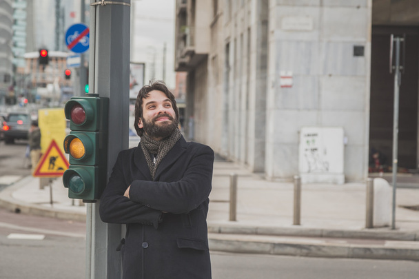 Young handsome bearded man posing in the city streets - Φωτογραφία, εικόνα