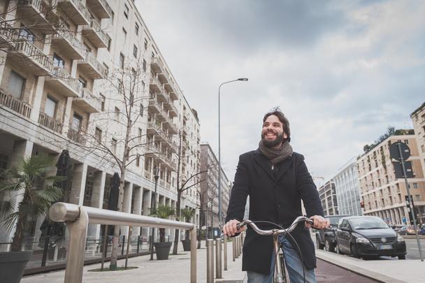 Young handsome bearded man posing with his bicyle - Photo, image