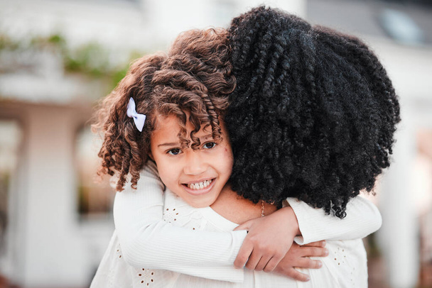 Portrait of girl hugging mother for love, affection and bonding in garden for relaxing, quality time and care outdoors. Family, smile and mom in child embrace on summer vacation, weekend and holiday. - Fotó, kép
