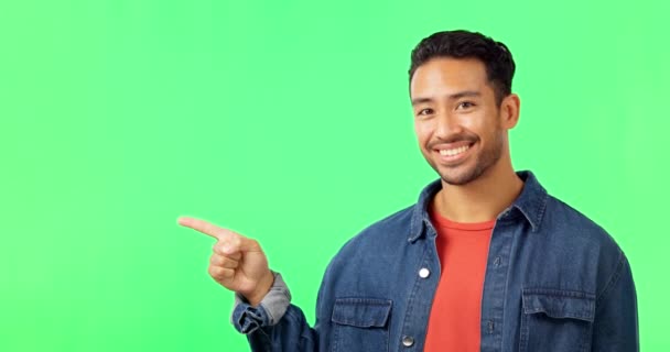 Smile, face and man hand pointing to green screen studio for commercial promotion, advertising and mockup. Portrait, happy and asian male showing space, product placement and isolated copy space. - Footage, Video