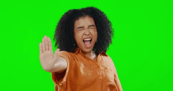 Stop, angry and face of a woman on a green screen isolated on a studio background. Frustrated, anger and portrait of a girl with a hand gesture for rejection, decline and disagreement on a backdrop. - Кадры, видео