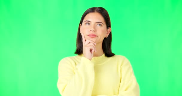 Mind, thinking and decision with a woman on a green screen background in studio to consider an option. Idea, face and contemplating with an attractive young female looking thoughtful on chromakey. - Video, Çekim