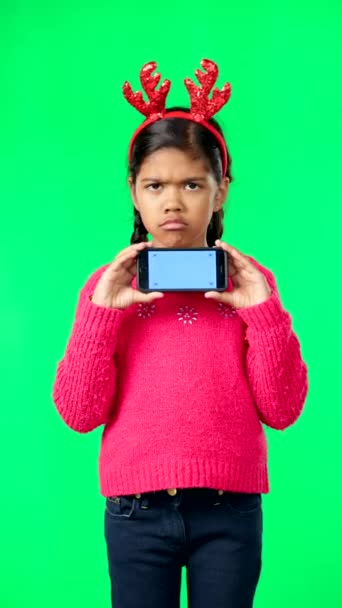 Christmas face, green screen and kid with phone in studio isolated on a background with tracking markers. Mockup, xmas and sad or unhappy girl with mobile smartphone for unwanted gift - Filmmaterial, Video