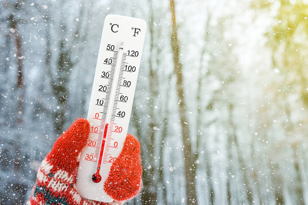Valkoinen celsiusasteikko ja fahrenheit asteikko lämpömittari kädessä. Lämpötila miinus 2 celsiusastetta - Valokuva, kuva
