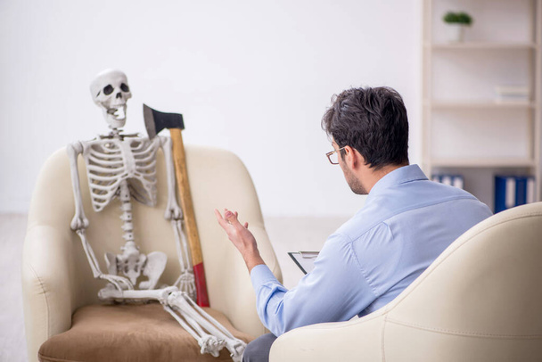 Young psychologist meeting with skeleton - Foto, Bild