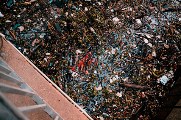 Waterway clogged with plastic pollution and other garbage. - Φωτογραφία, εικόνα