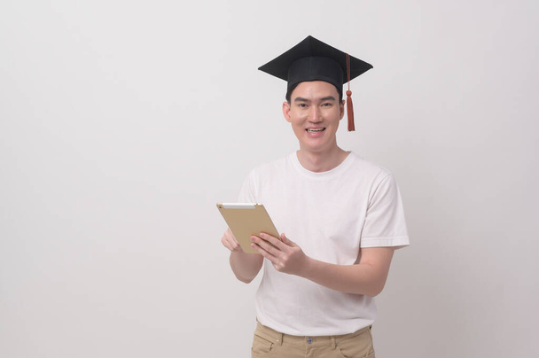 Young smiling man holding graduation hat, education and university concept	 - Φωτογραφία, εικόνα