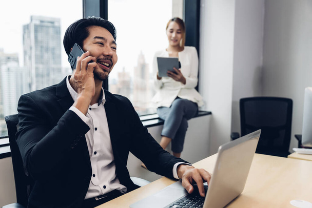 Call center business woman talking on headset. Call center worker accompanied by her team. Customer service executive working at office.	 - Foto, Imagem