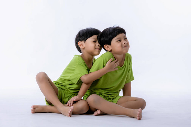 Portrait of cute Asian twins boys. two little boys twins isolated on white background. twins boys fun together on white background - Фото, зображення