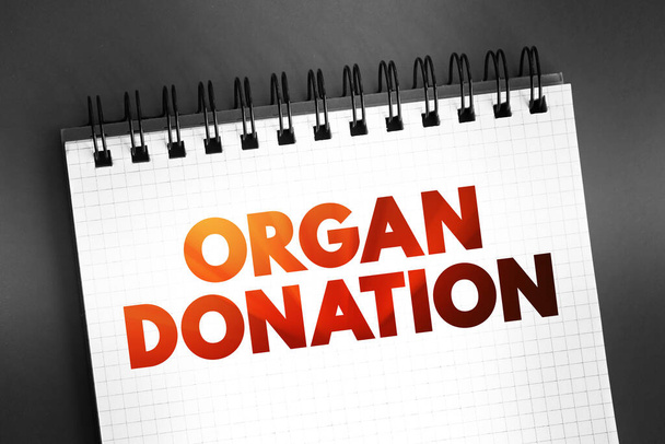 Organ Donation - process of surgically removing an organ or tissue from one person and placing it into another person, text on notepad, concept background - Фото, зображення