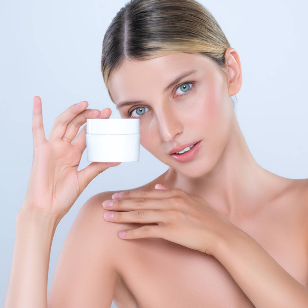 Alluring beautiful perfect cosmetic skin woman portrait hold mockup jar cream or moisturizer for skincare treatment, anti-aging product in isolated background. Natural healthy skin model concept. - Photo, Image