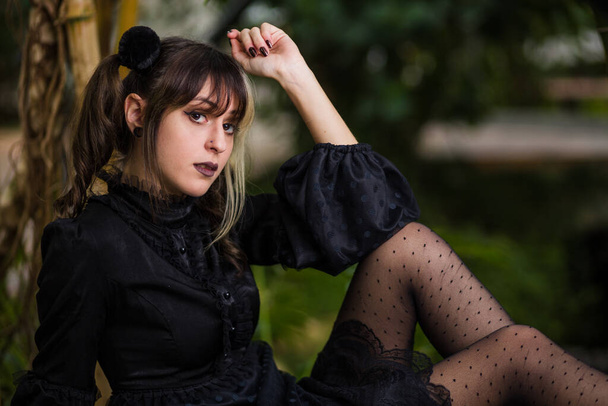 style anime brunette model with old fashioned vintage dress on flower background for halloween horror and mystery cosplay  - 写真・画像