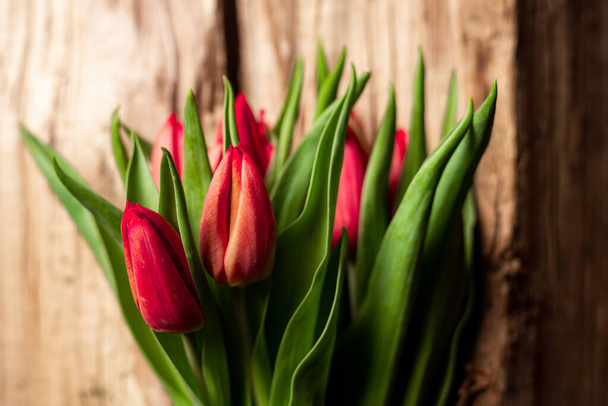 Bouquet of tulips on wooden background. Gift, concept of spring. Mother's Day Greetings - Valokuva, kuva