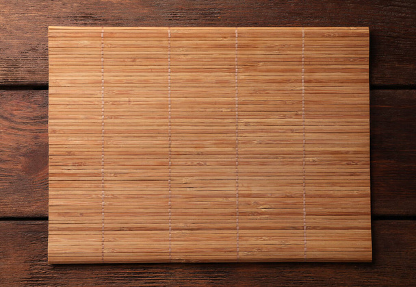 Bamboo mat on wooden table, top view. Space for text - Foto, immagini