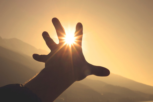 Hand trying to grab the sun - Photo, Image