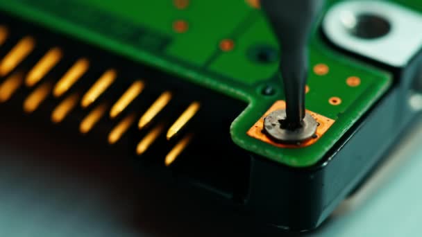 El reparador aprieta el tornillo del disco duro con un destornillador. El técnico instala el nuevo procesador en la placa base - Metraje, vídeo