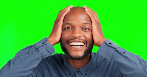Portrait, wow and good news with a black man on a green screen background, mind blown in studio. Face, surprise and hands on head with a happy young make looking shocked on chromakey mockup. - Footage, Video