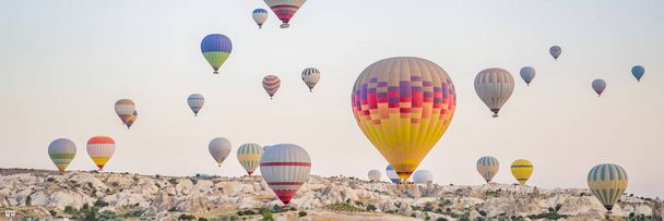 Colorful hot air balloon flying over Cappadocia, Turkey. BANNER, LONG FORMAT - Foto, imagen